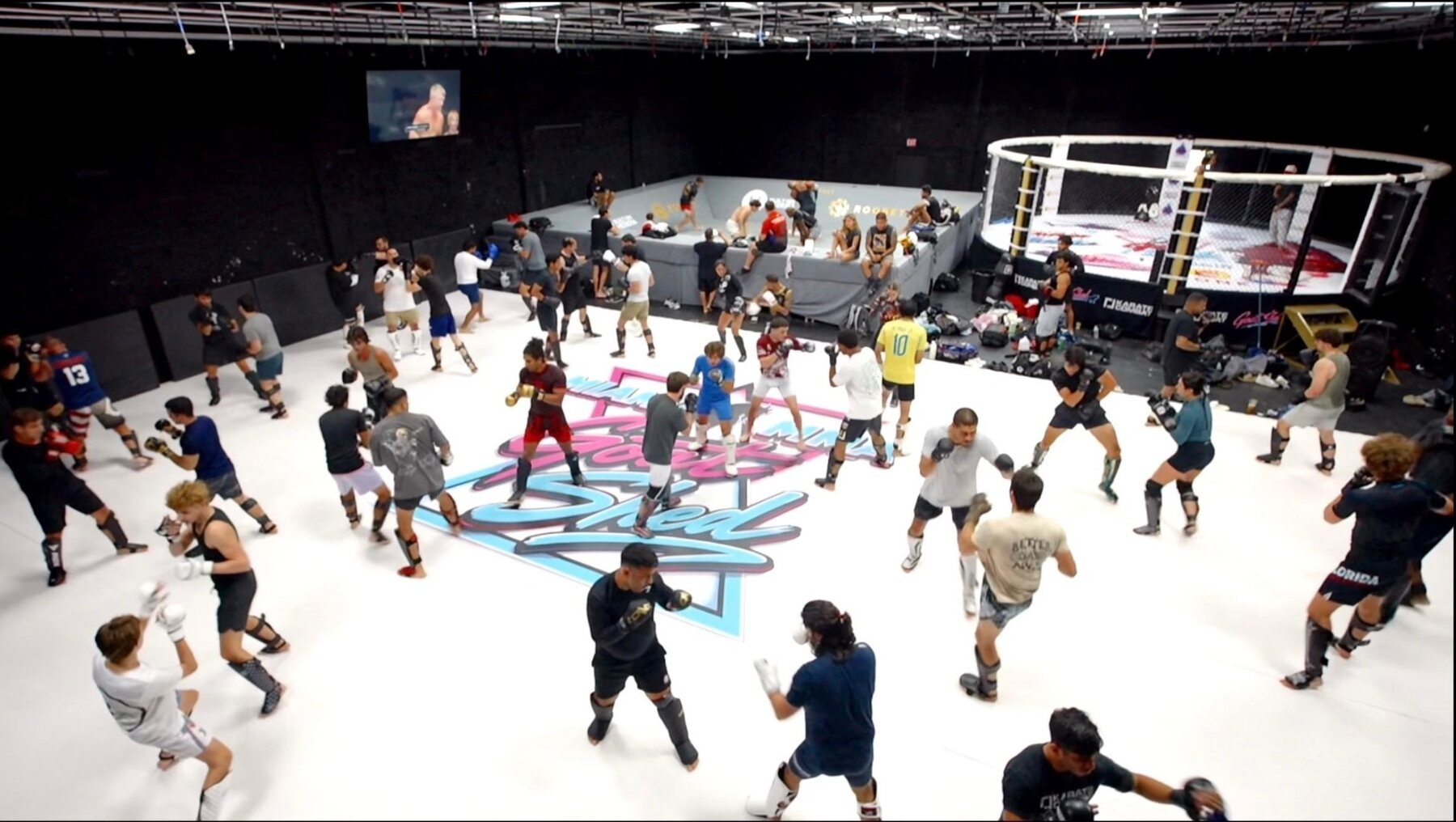 A packed martial arts training session on the white mats at Goat Shed Doral
